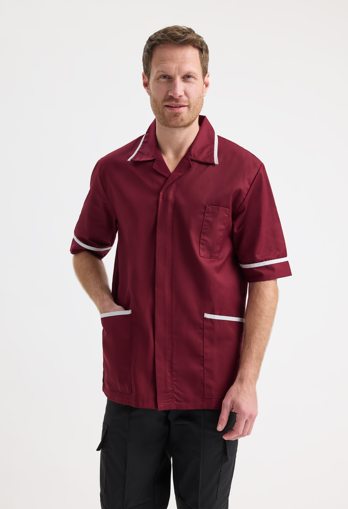 Male nurse wearing a maroon nursing tunic